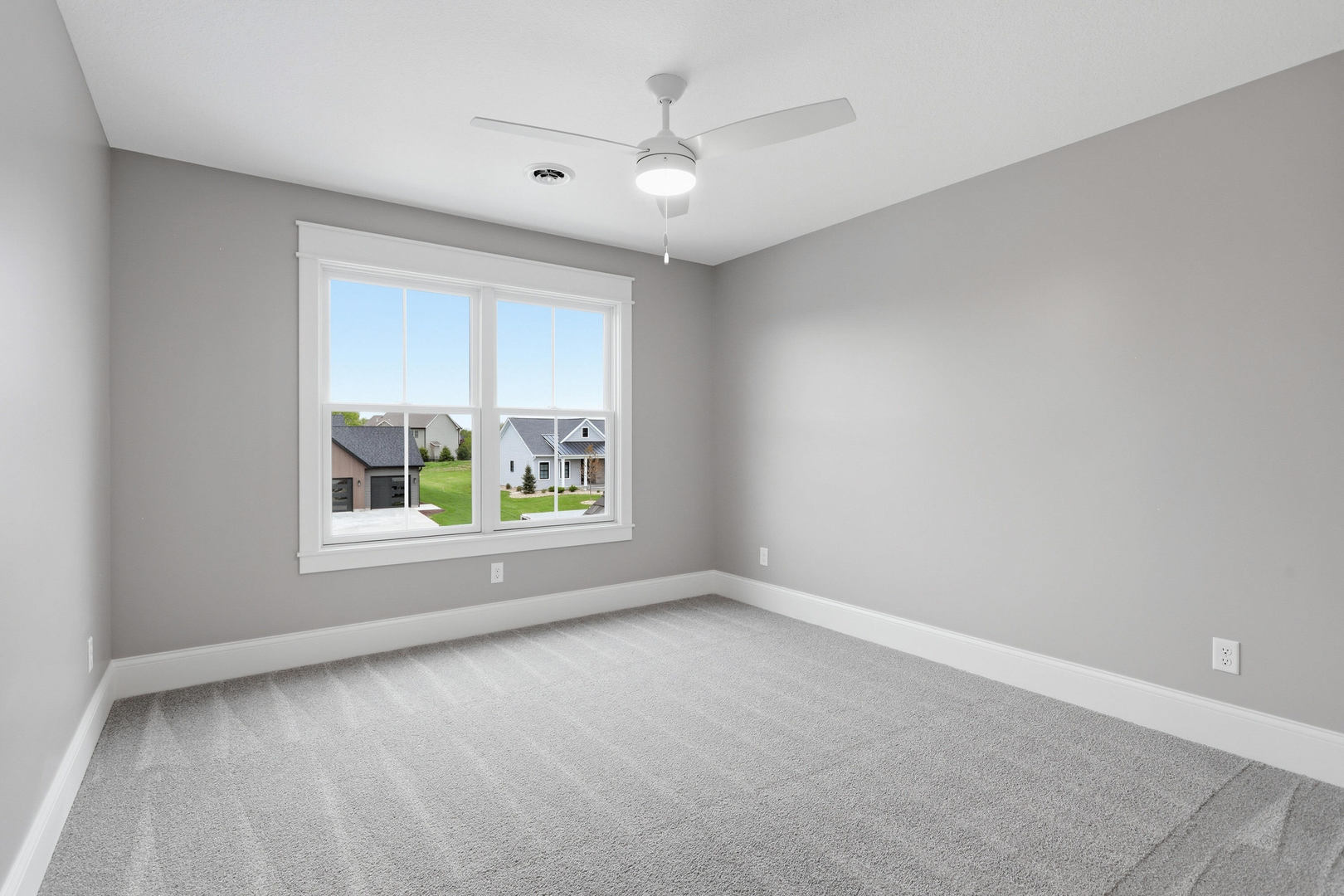 6928 Wilderness Pointe Bettendorf, IA 52722 - Photo 41 of 48 an empty room with windows and ceiling fan