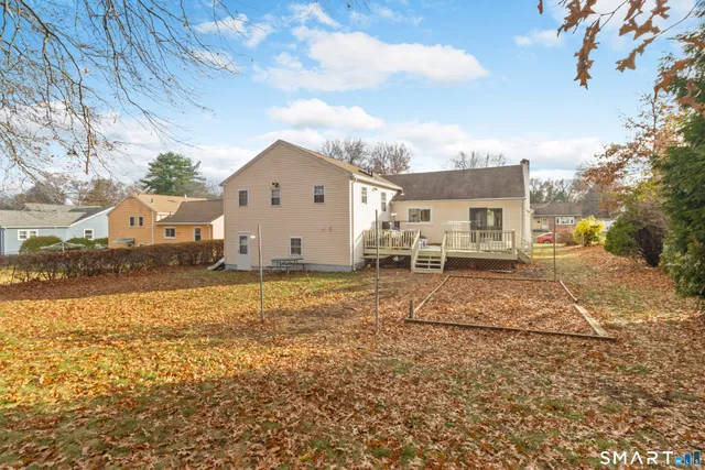 a view of house with backyard and trees