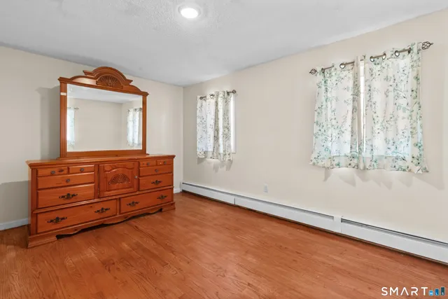 a room with a dresser and a window