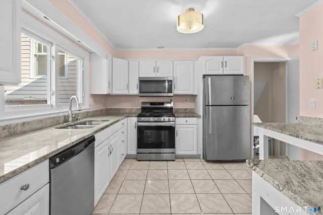 a kitchen with a stove a refrigerator and a sink