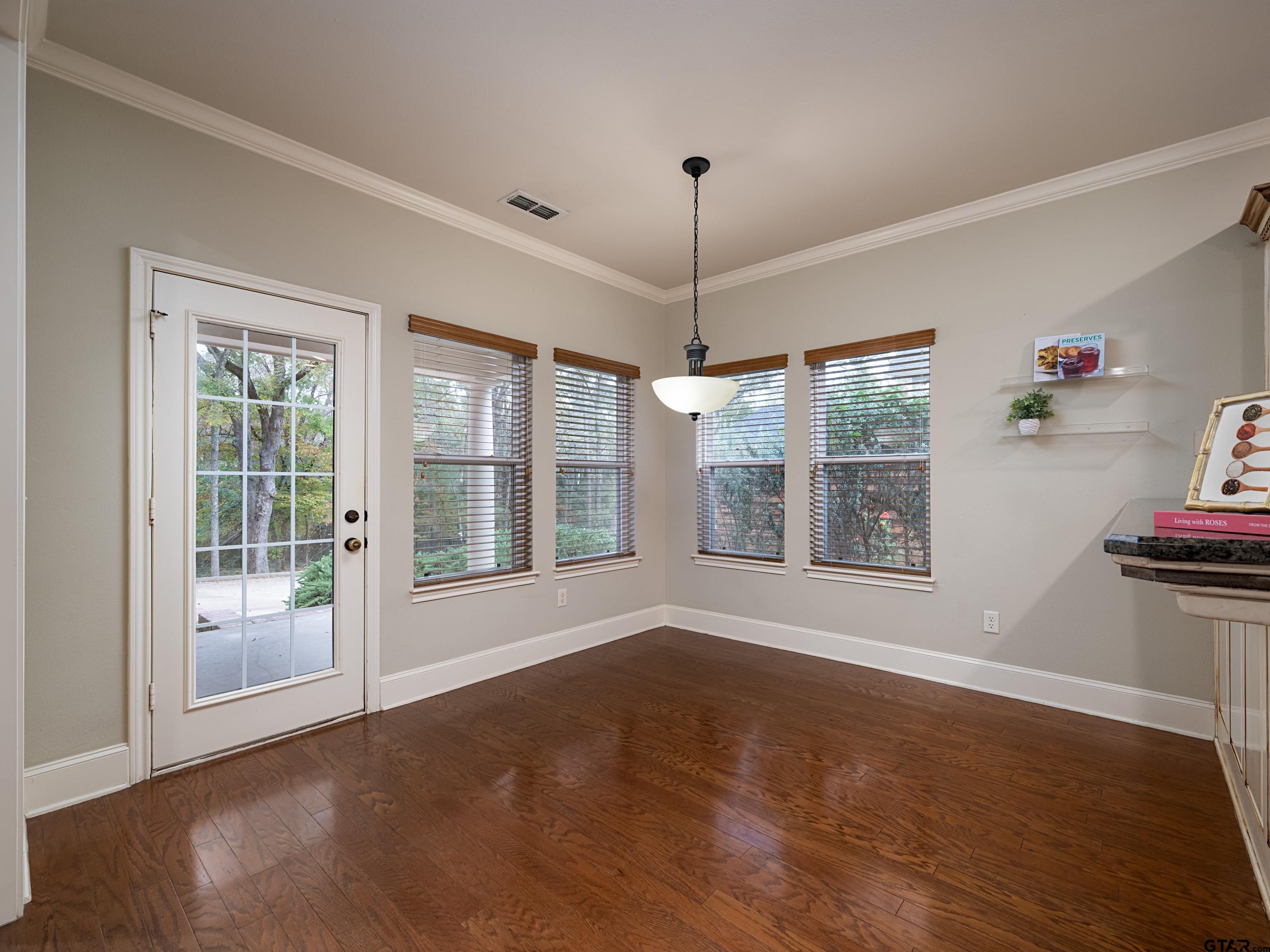 3950 Hanover Place Tyler, TX 75701 - Photo 14 of 44 a view of an empty room with wooden floor and a window