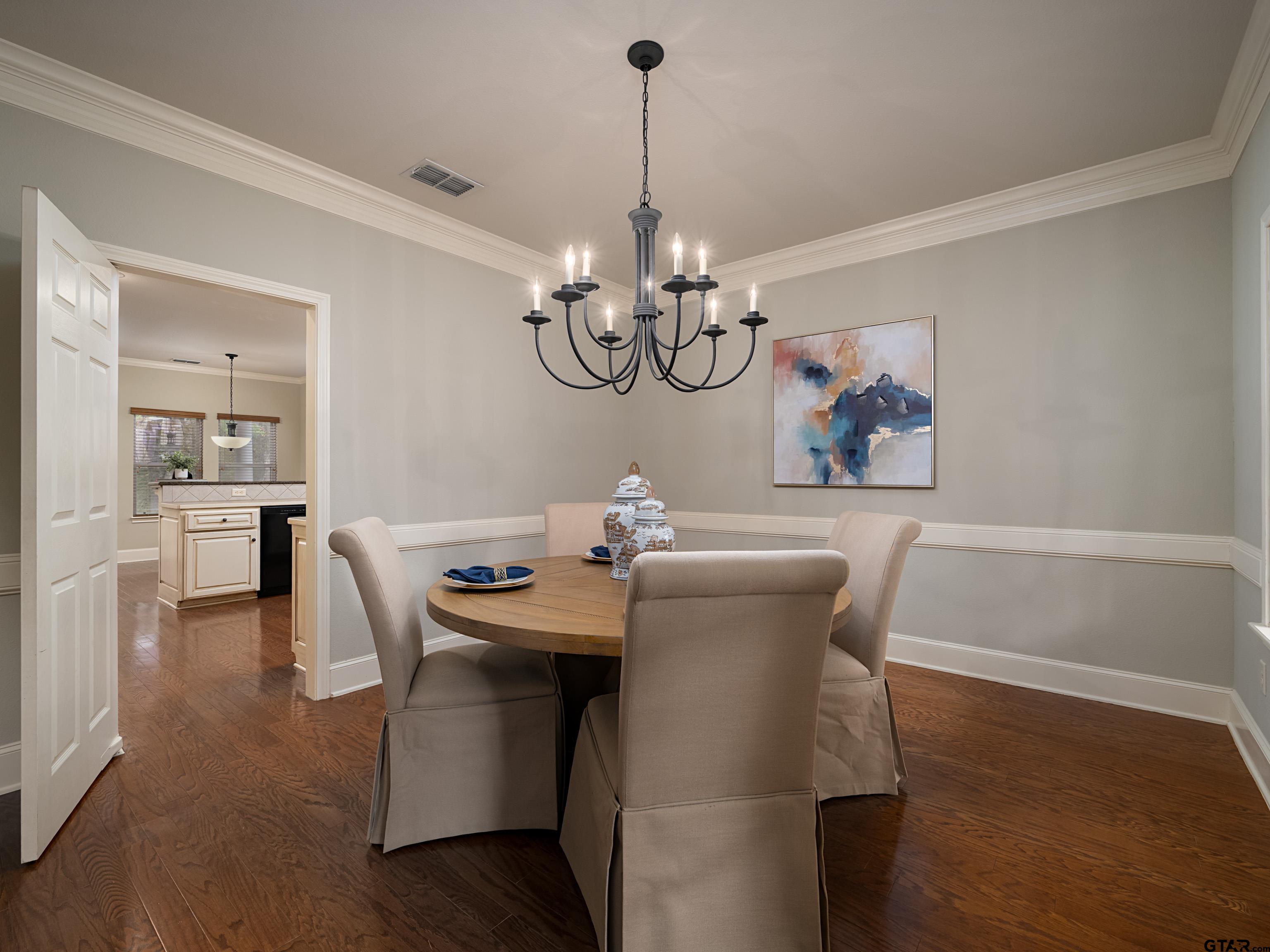 3950 Hanover Place Tyler, TX 75701 - Photo 16 of 44 a view of a dining room with furniture wooden floor and chandelier