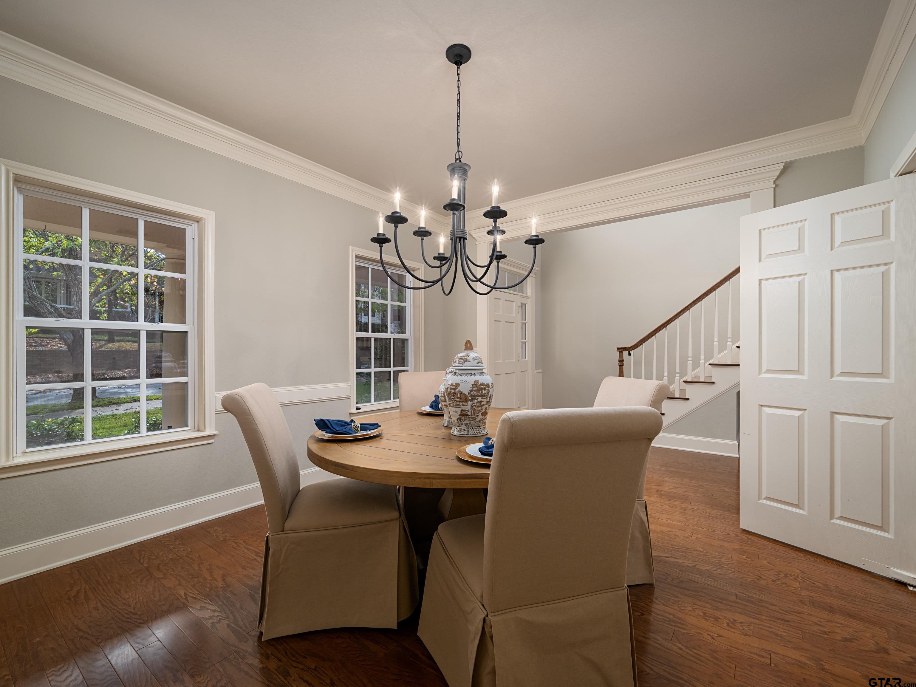 3950 Hanover Place Tyler, TX 75701 - Photo 17 of 44 a dining room with furniture a chandelier and wooden floor
