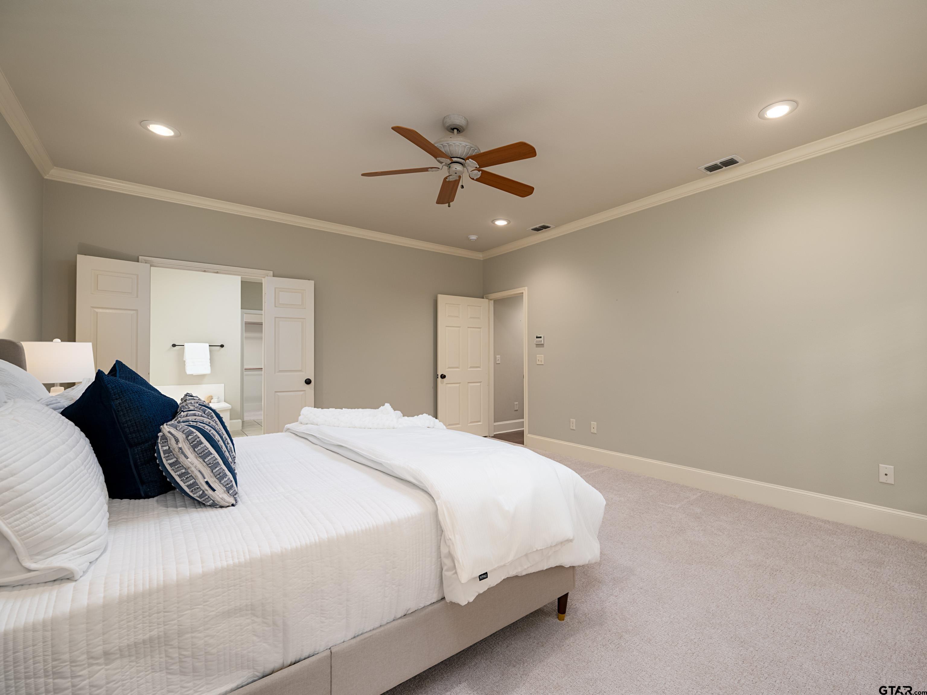 3950 Hanover Place Tyler, TX 75701 - Photo 19 of 44 a bedroom with a bed and a ceiling fan