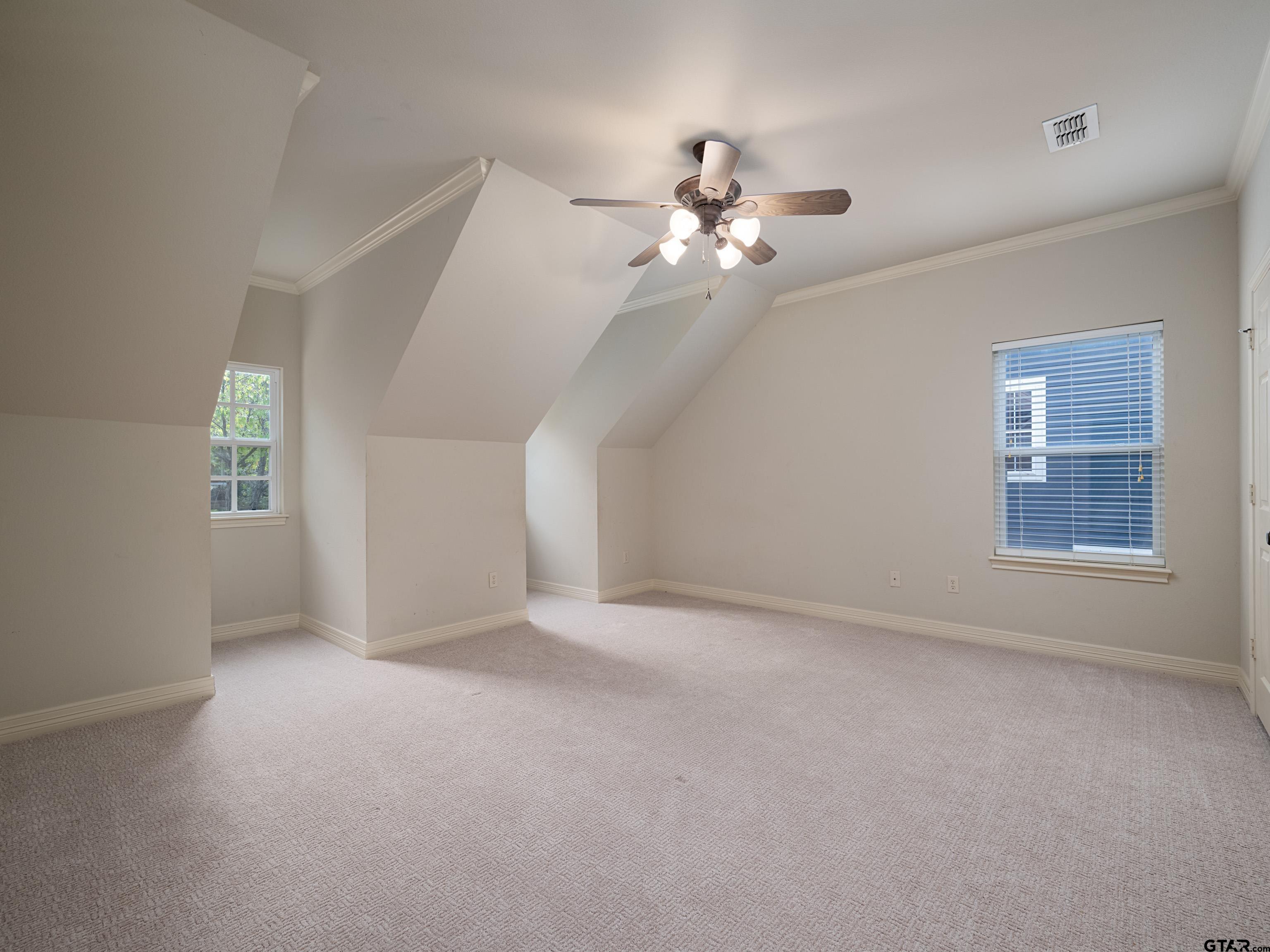 3950 Hanover Place Tyler, TX 75701 - Photo 24 of 44 an empty room with windows and fan