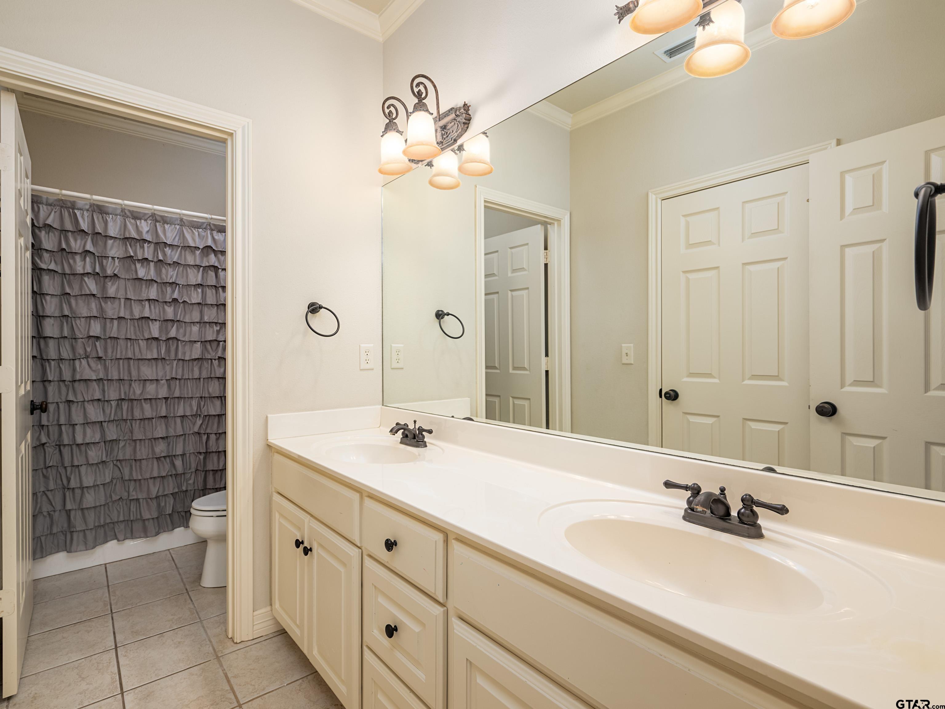 3950 Hanover Place Tyler, TX 75701 - Photo 28 of 44 a bathroom with a double vanity sink and a mirror