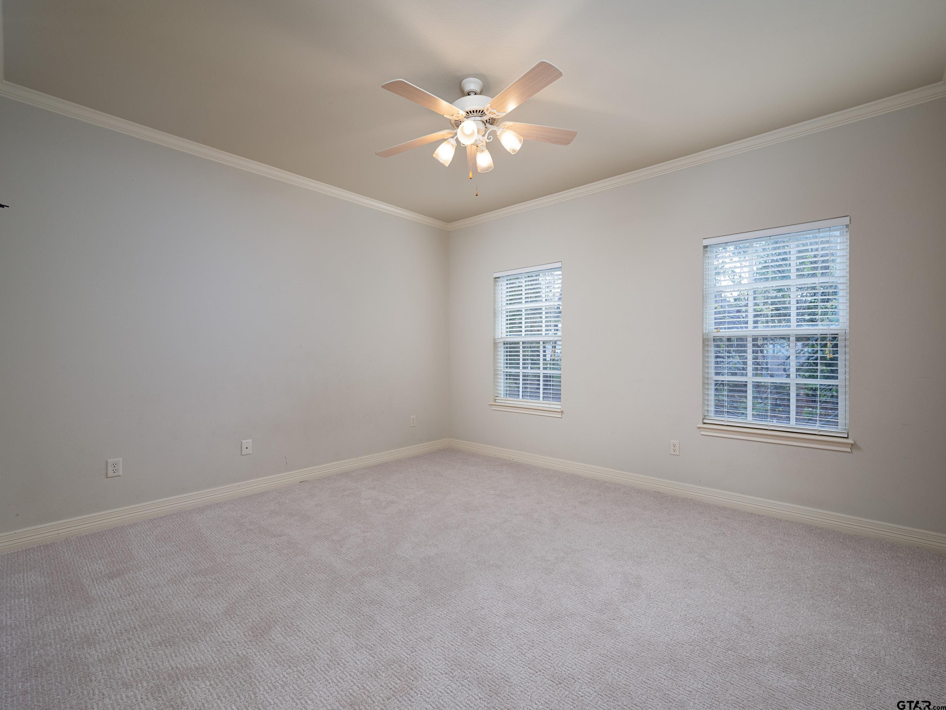 3950 Hanover Place Tyler, TX 75701 - Photo 29 of 44 an empty room with window and ceiling fan