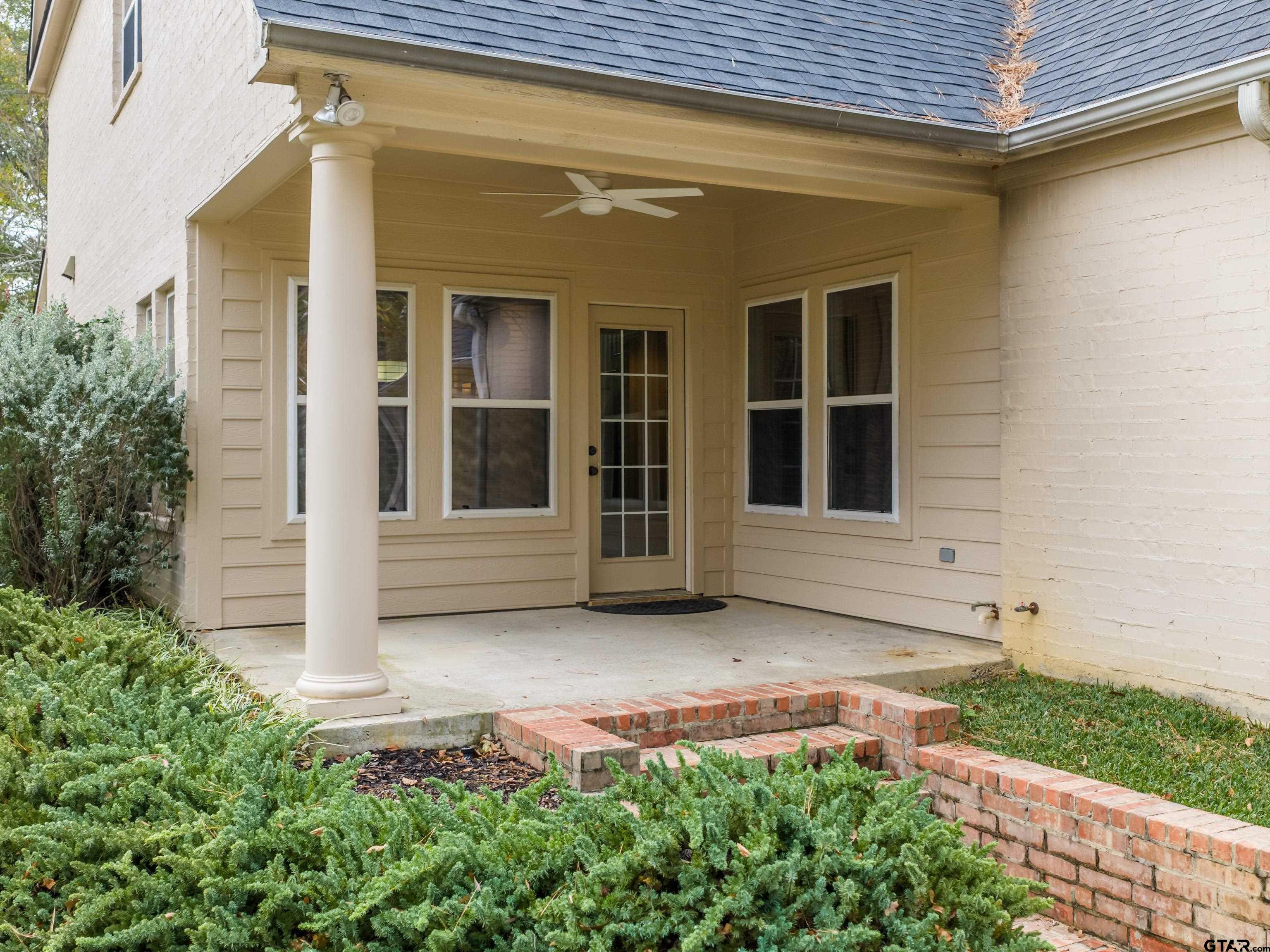 3950 Hanover Place Tyler, TX 75701 - Photo 35 of 44 front view of a house with a large window and potted plants