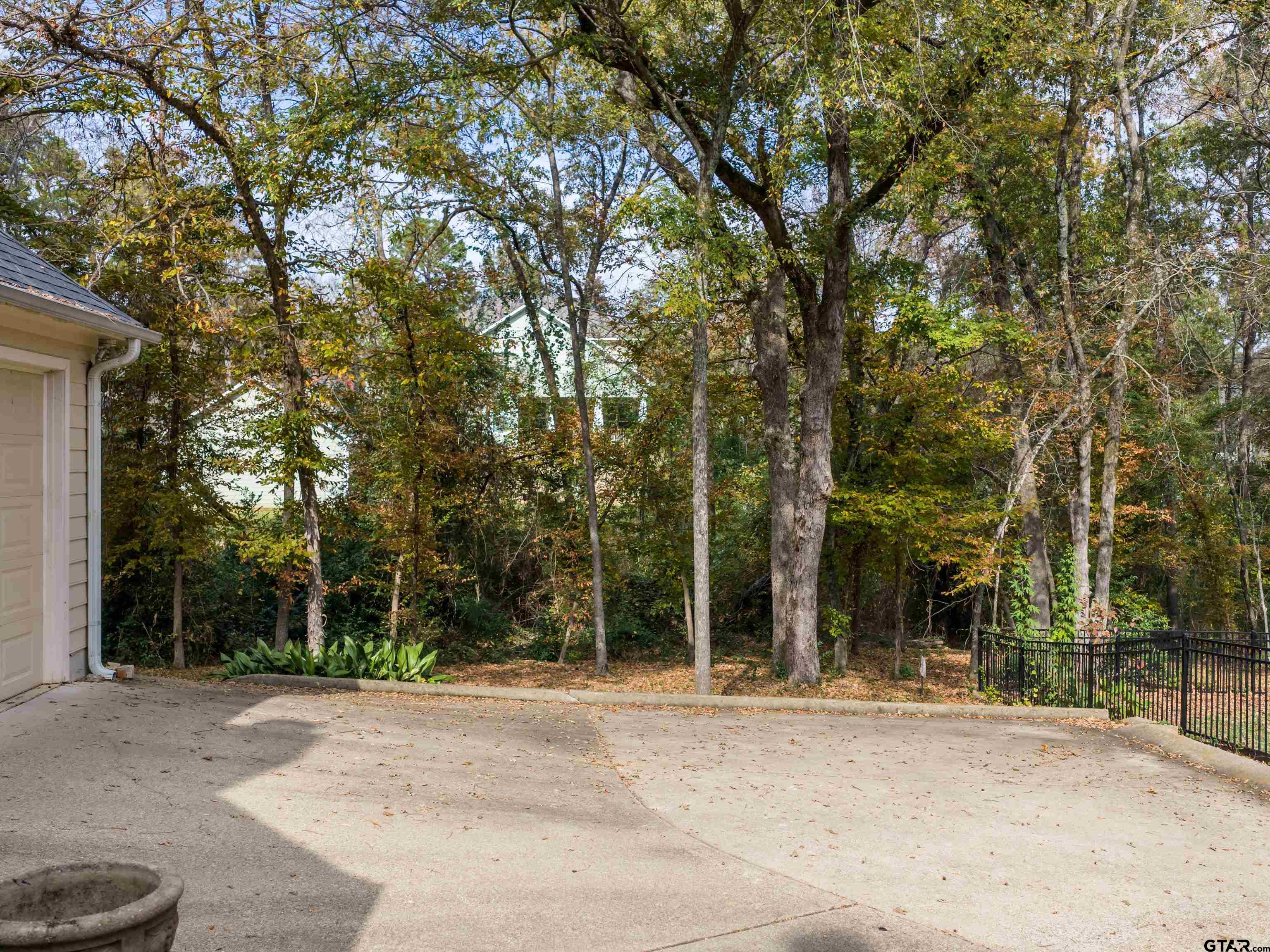 3950 Hanover Place Tyler, TX 75701 - Photo 37 of 44 a view of a house with a trees and plants
