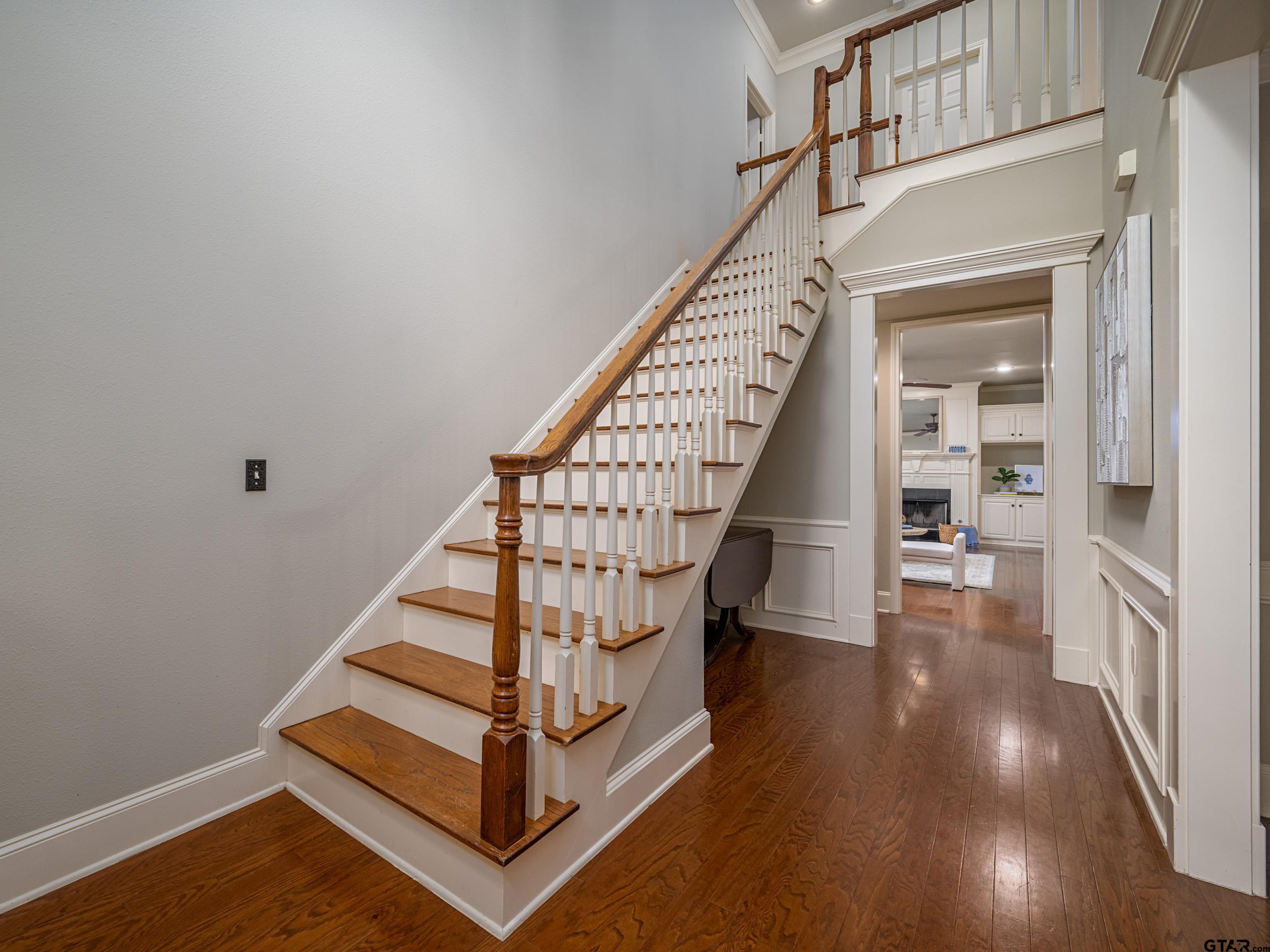 3950 Hanover Place Tyler, TX 75701 - Photo 7 of 44 a view of entryway with wooden floor and stairs