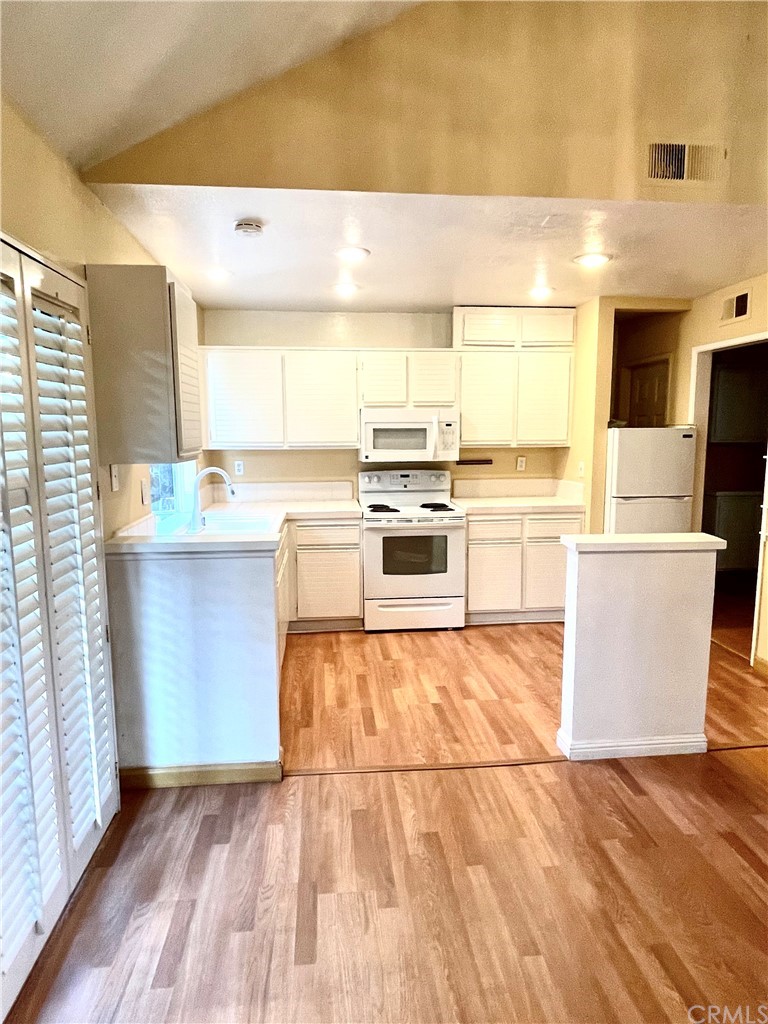 48 Riverstone, Unit 60 Irvine, CA 92606 - Photo 11 of 31 a kitchen with stainless steel appliances granite countertop a stove a sink and a refrigerator