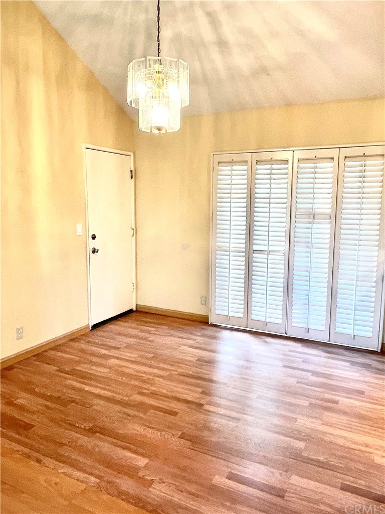 48 Riverstone, Unit 60 Irvine, CA 92606 - Photo 12 of 31 a view of a livingroom with wooden floor and a chandelier