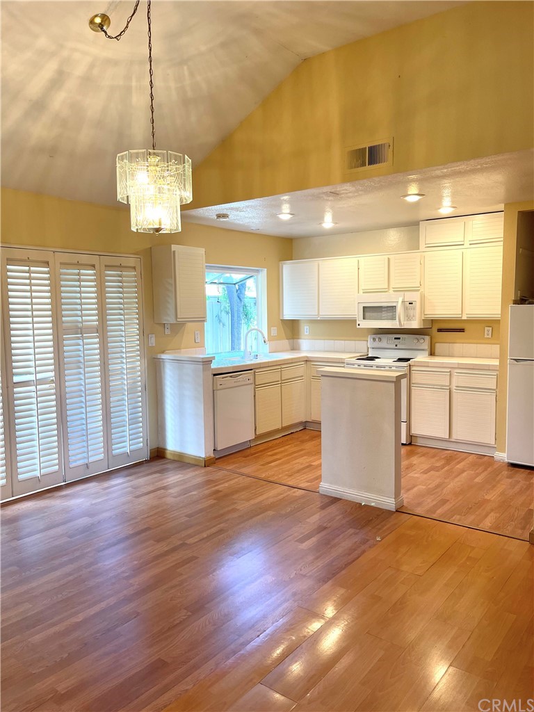 48 Riverstone, Unit 60 Irvine, CA 92606 - Photo 10 of 31 a view of a kitchen with a sink wooden floor and a window