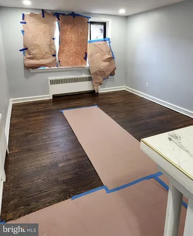 a view of hallway with wooden floor