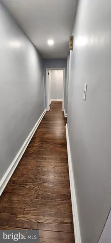 a view of a room with wooden floor and window