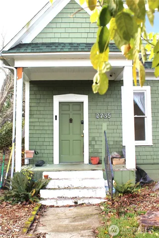 a front view of a house with fountain