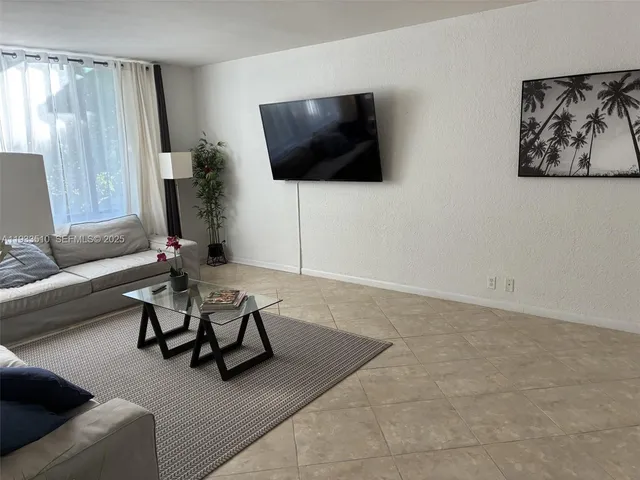 a view of a livingroom with furniture and a flat screen tv