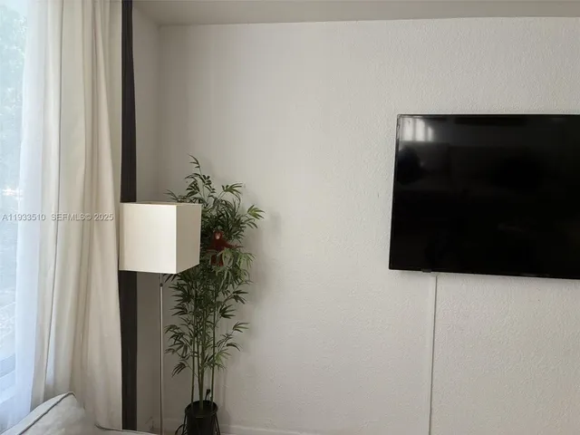 a room with a potted plant on a wall and a potted plant