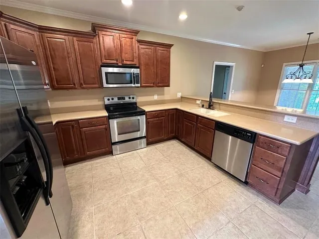 a kitchen with wooden cabinets and a sink