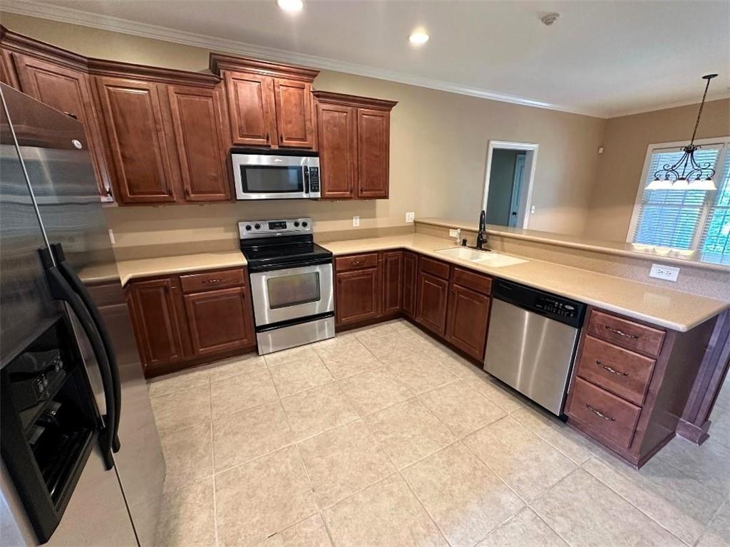 107 Savoy Place Calhoun, GA 30701 - Photo 13 of 32 a kitchen with wooden cabinets and a sink