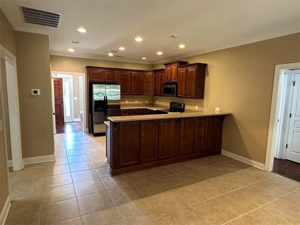 107 Savoy Place Calhoun, GA 30701 - Photo 14 of 32 a kitchen with stainless steel appliances granite countertop a sink and cabinets