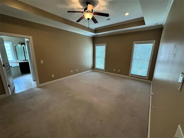 a view of a livingroom with a ceiling fan and window