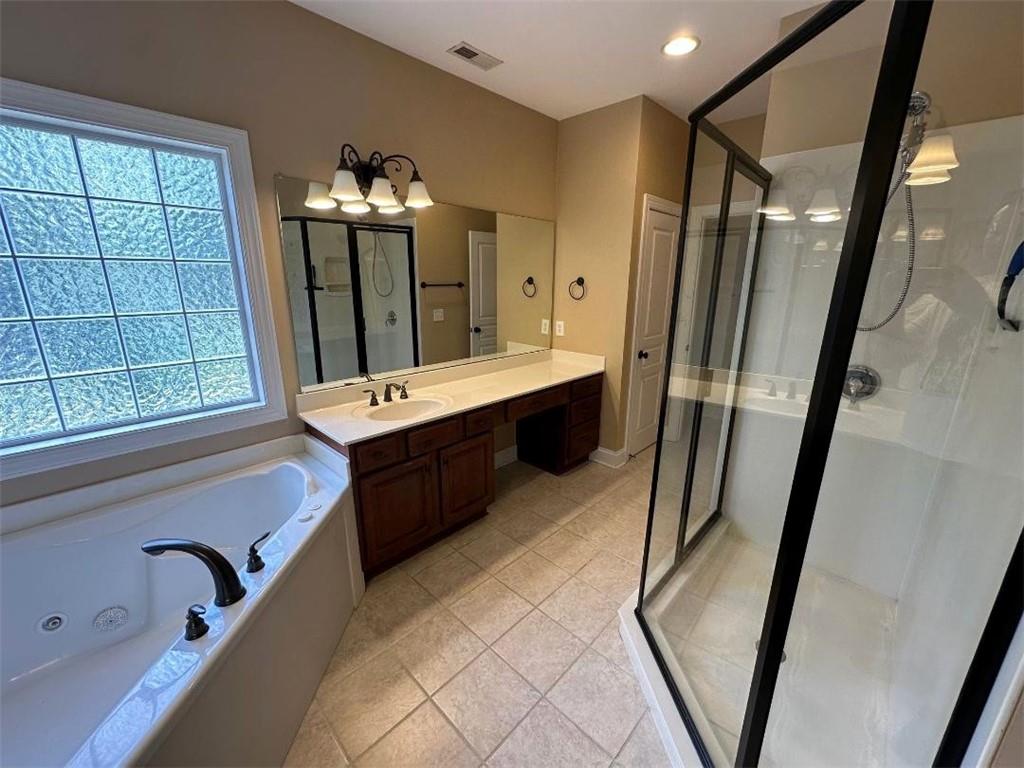 107 Savoy Place Calhoun, GA 30701 - Photo 18 of 32 a bathroom with a double vanity sink a mirror and a bathtub