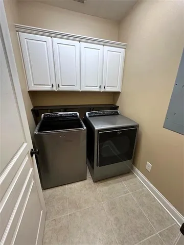 a kitchen with white cabinets and a stove