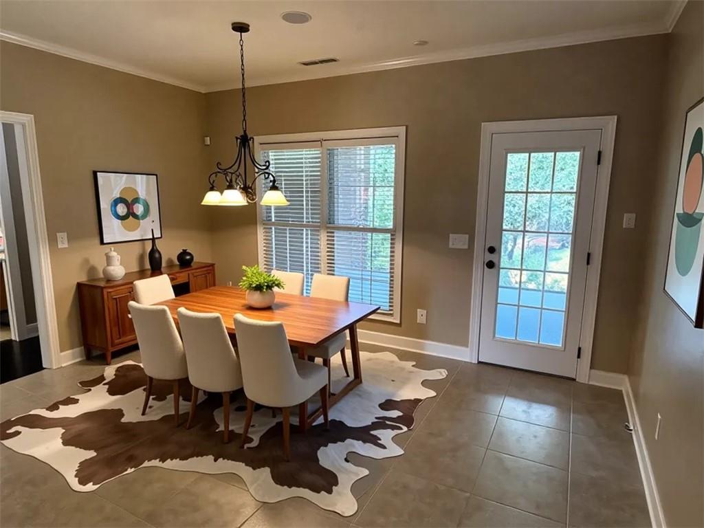 107 Savoy Place Calhoun, GA 30701 - Photo 5 of 32 a dining room with wooden floor a chandelier a wooden table and chairs