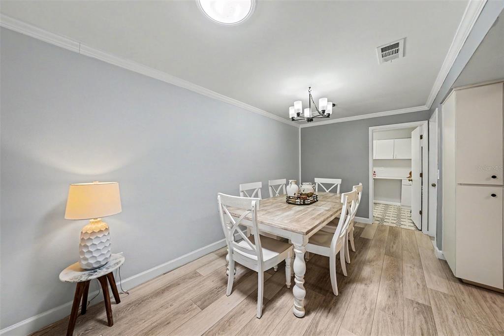 9204 Golf View Drive New Port Richey, FL 34655 - Photo 8 of 33 a view of a dining room with furniture and wooden floor