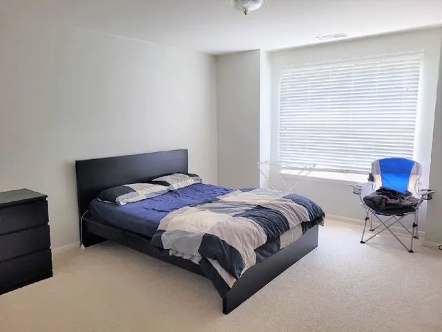 a bedroom with a bed and window