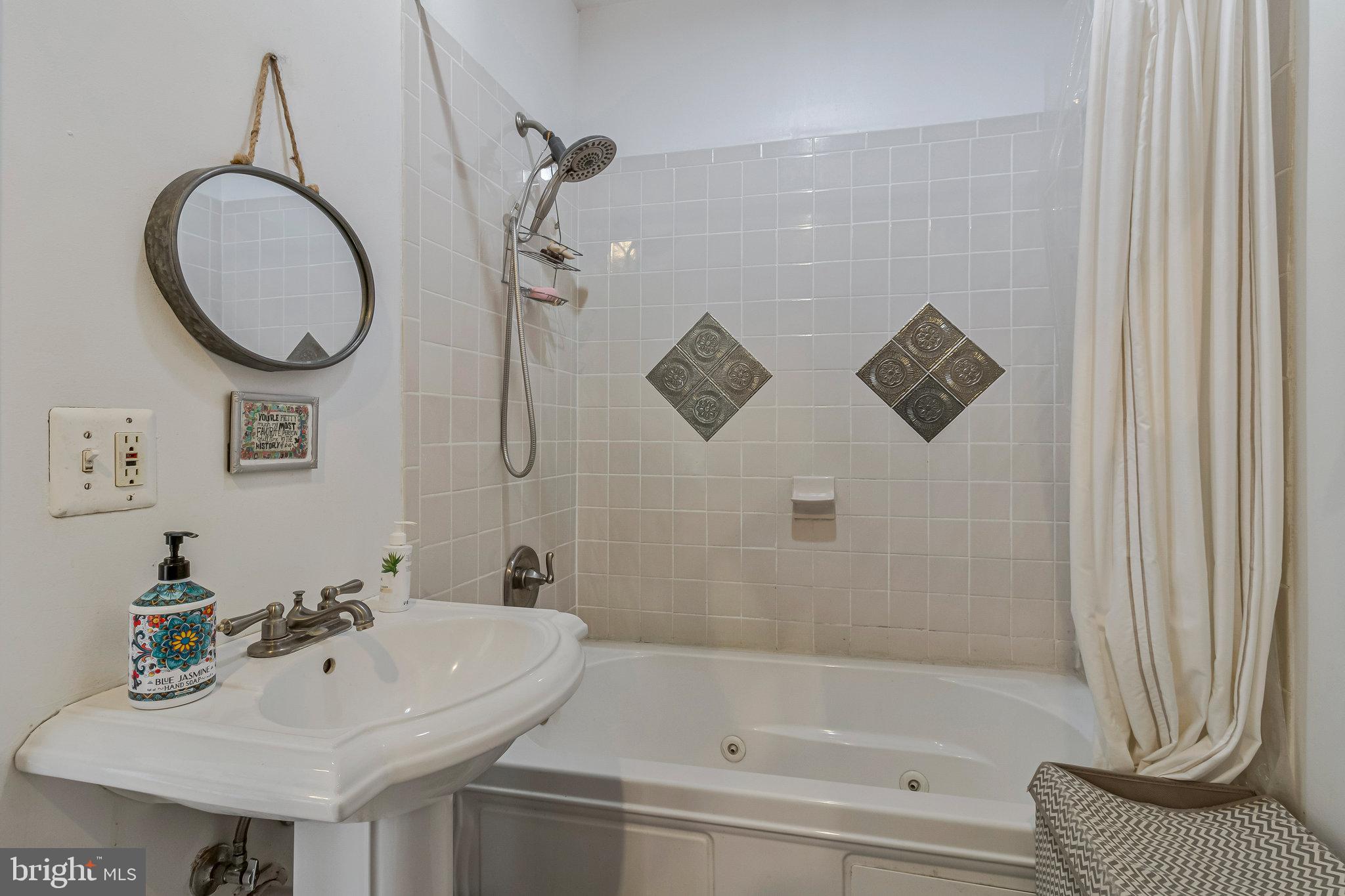 902 Westminster Street Northwest Washington, DC 20001 - Photo 12 of 20 a bathroom with a sink a toilet and a bathtub