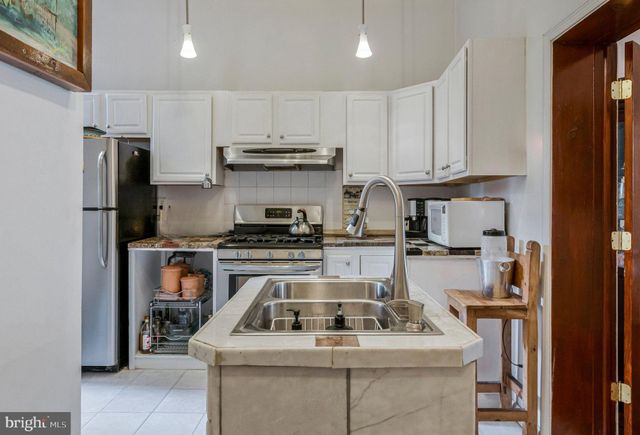 a kitchen with a stove and a refrigerator