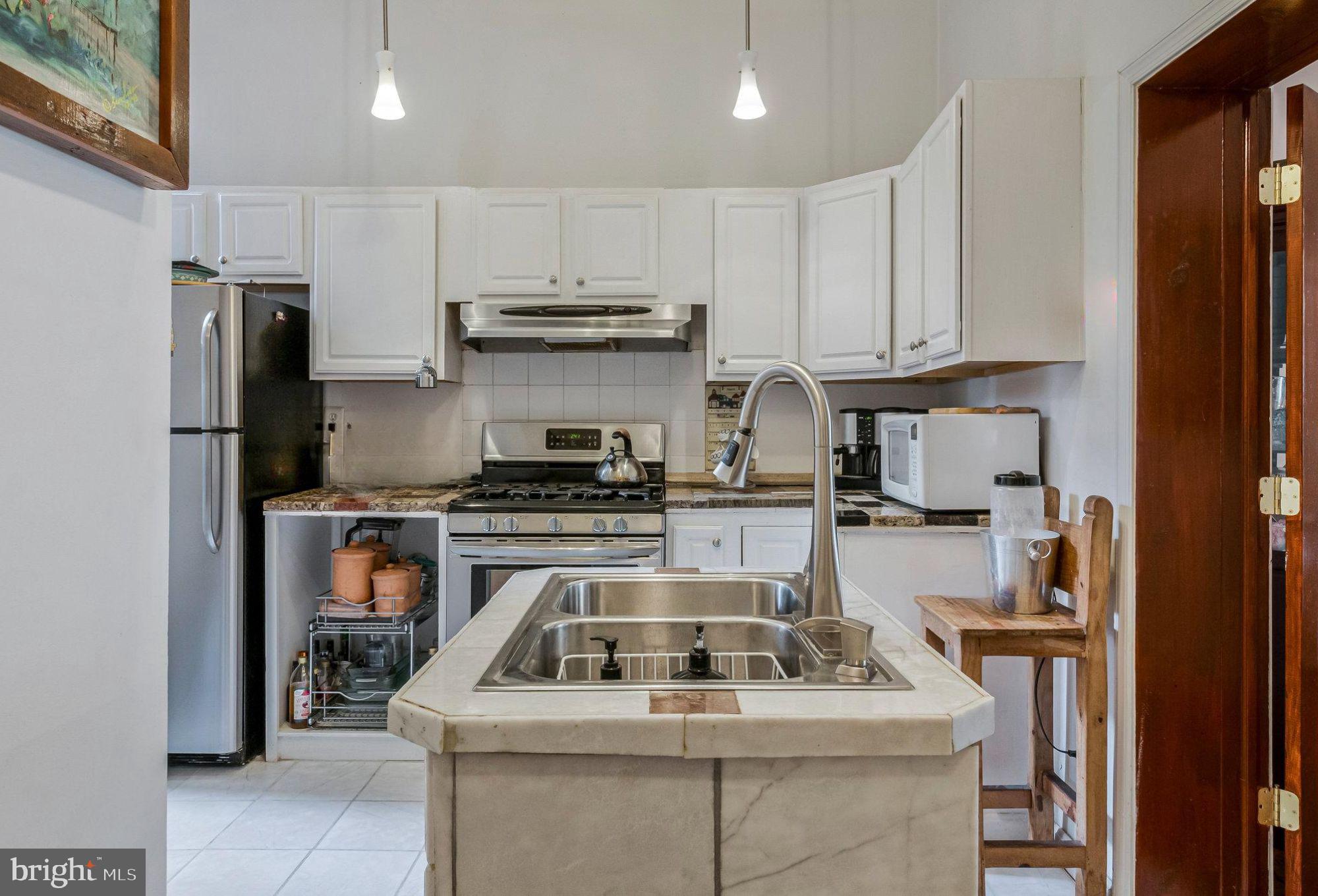 902 Westminster Street Northwest Washington, DC 20001 - Photo 2 of 20 a kitchen with a stove and a refrigerator