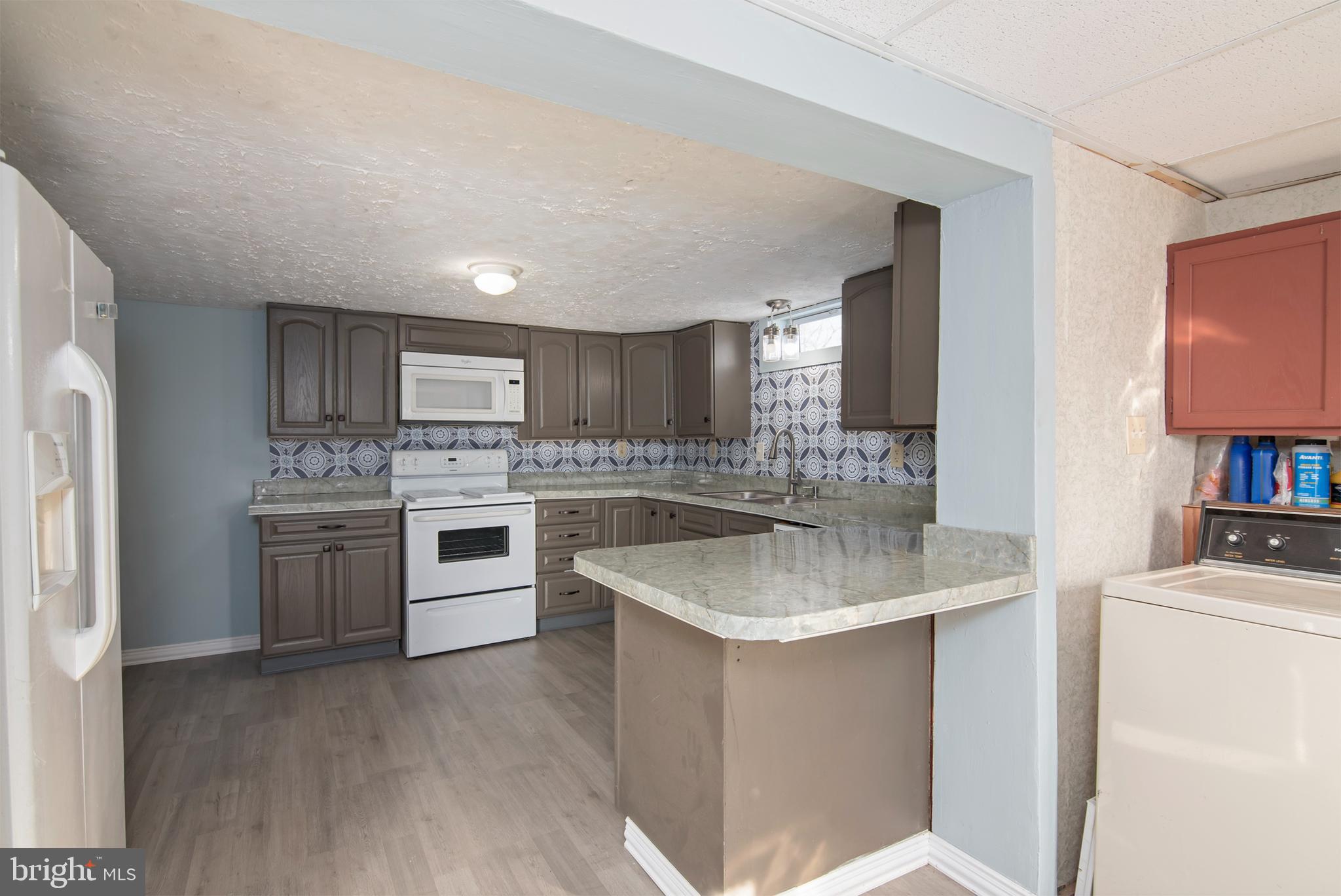 5880 Wheatley Church Road Rhodesdale, MD 21659 - Photo 13 of 27 a kitchen with a sink stove and refrigerator