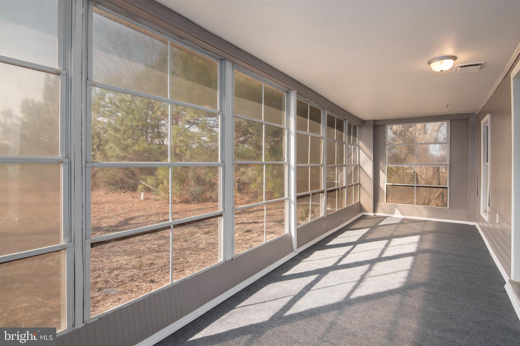 5880 Wheatley Church Road Rhodesdale, MD 21659 - Photo 7 of 27 a view of an empty room with a large window