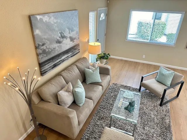 a living room with furniture and a painting