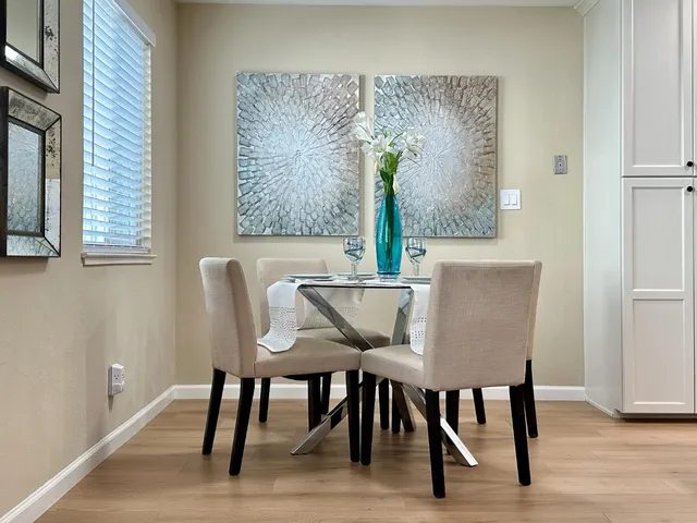a view of a dining room with furniture and wooden floor