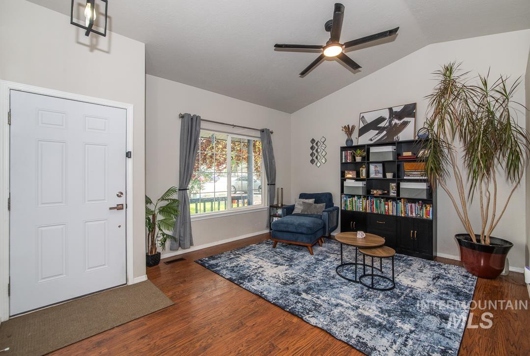 805 Bison Way Caldwell, ID 83607 - Photo 10 of 45 Vaulted ceiling living space featuring wood-finish flooring and a contemporary black ceiling fan
