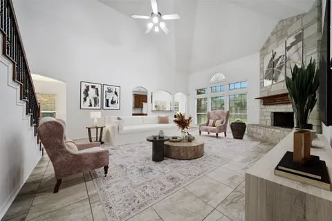 a spacious bedroom with a bed a couch and large window