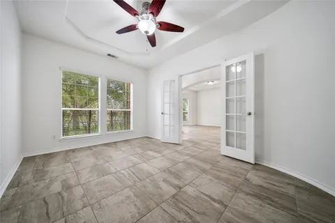a view of empty room with a fireplace and fan