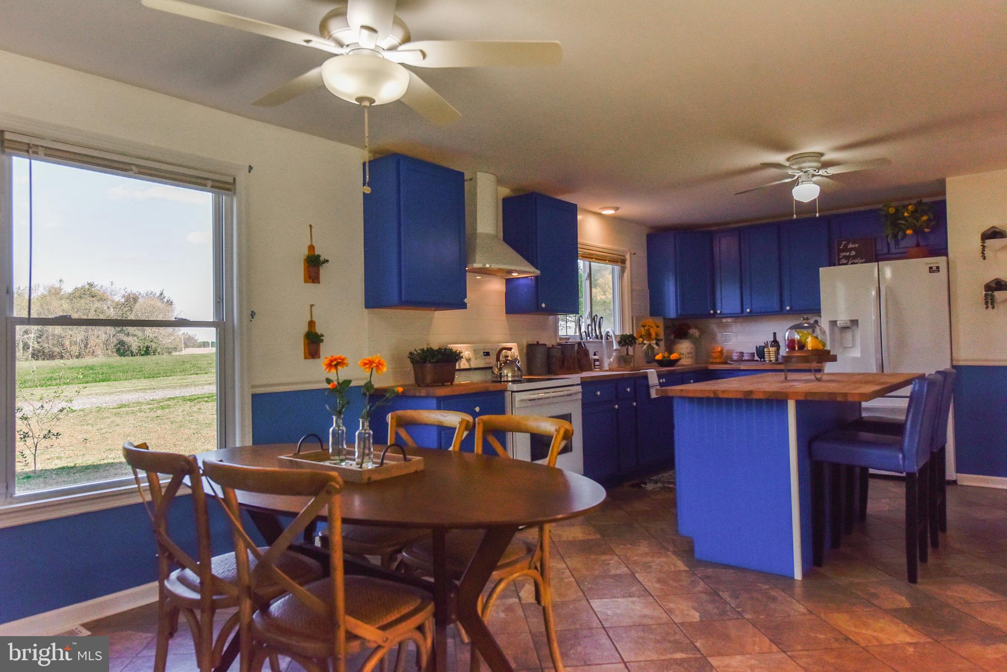 19 Harrisonville Lake Road Pilesgrove, NJ 08098 - Photo 3 of 44 a kitchen with a dining table chairs and refrigerator