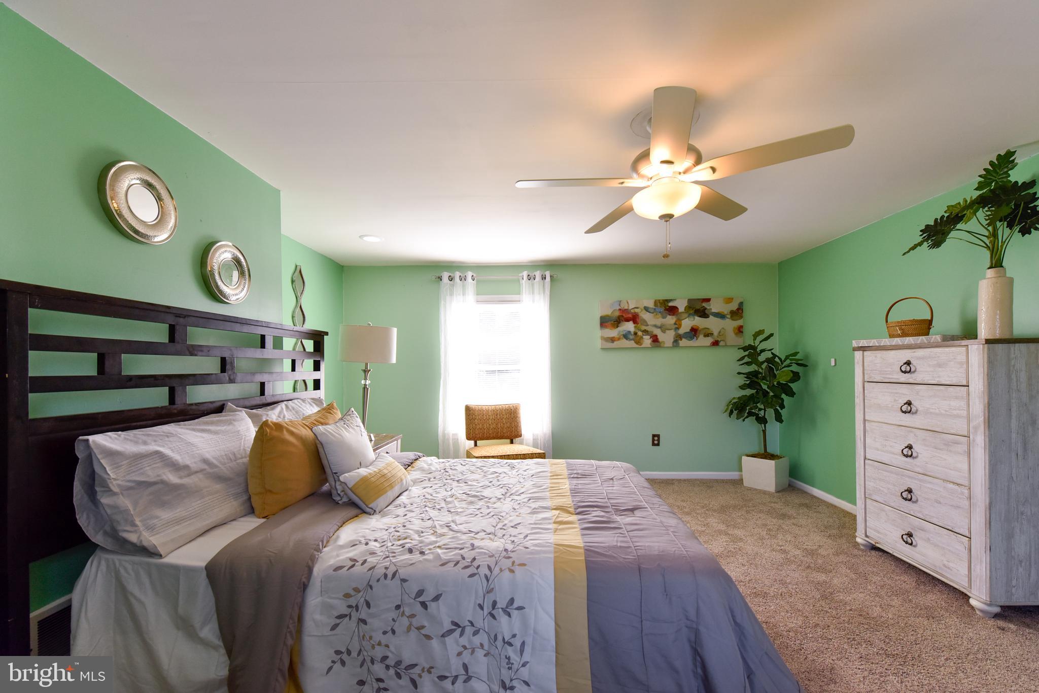 19 Harrisonville Lake Road Pilesgrove, NJ 08098 - Photo 29 of 44 a bedroom with a bed and a chandelier