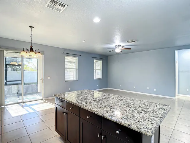 a large kitchen with stainless steel appliances kitchen island granite countertop a sink dishwasher stove top oven and cabinets