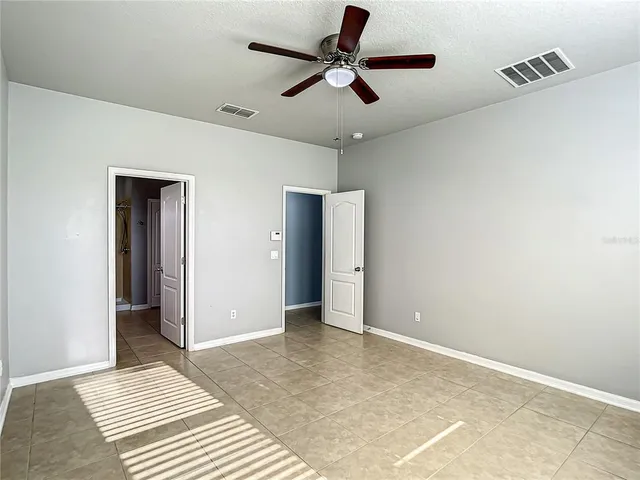 a bathroom with a granite countertop shower sink and mirror