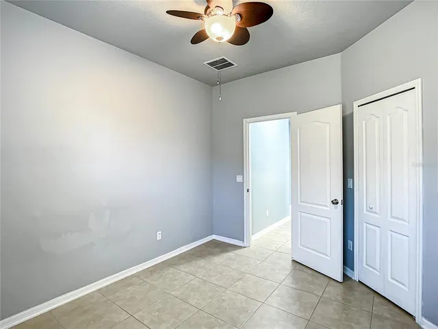 a living room with a floor to ceiling window and a table