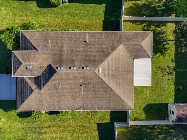 an aerial view of residential houses with outdoor space and street view