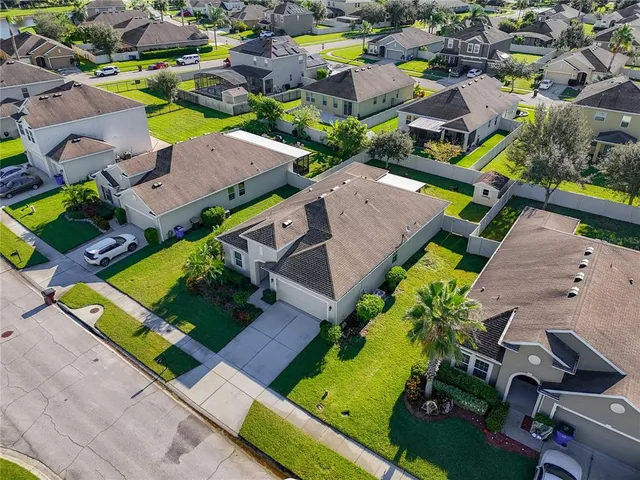 an aerial view of residential houses with outdoor space