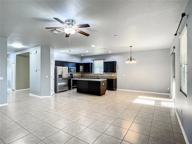 a kitchen with stainless steel appliances granite countertop a stove top oven and refrigerator
