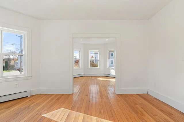 wooden floor in an empty room with a window